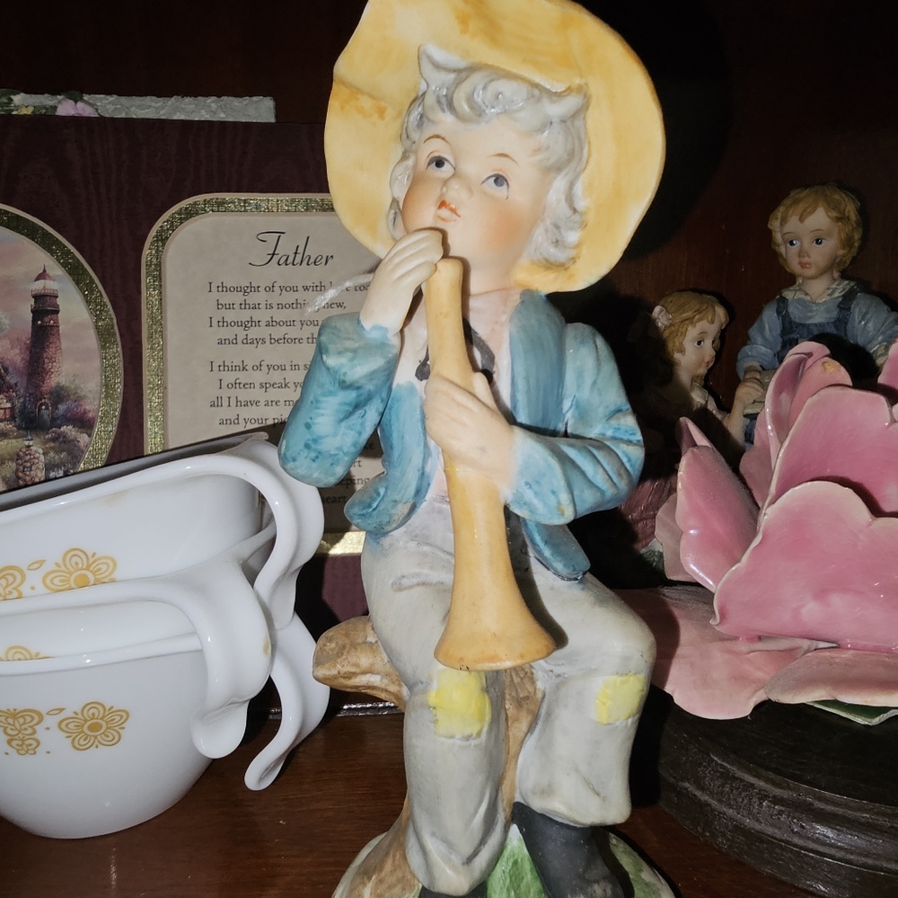 Vintage Capodimonte Country Boy with a Horn on a tree.